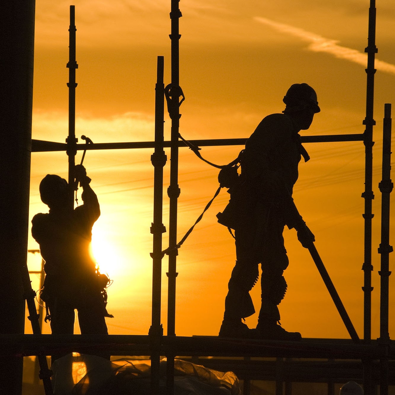 Construction photography of two silhouettes of professionals at a site