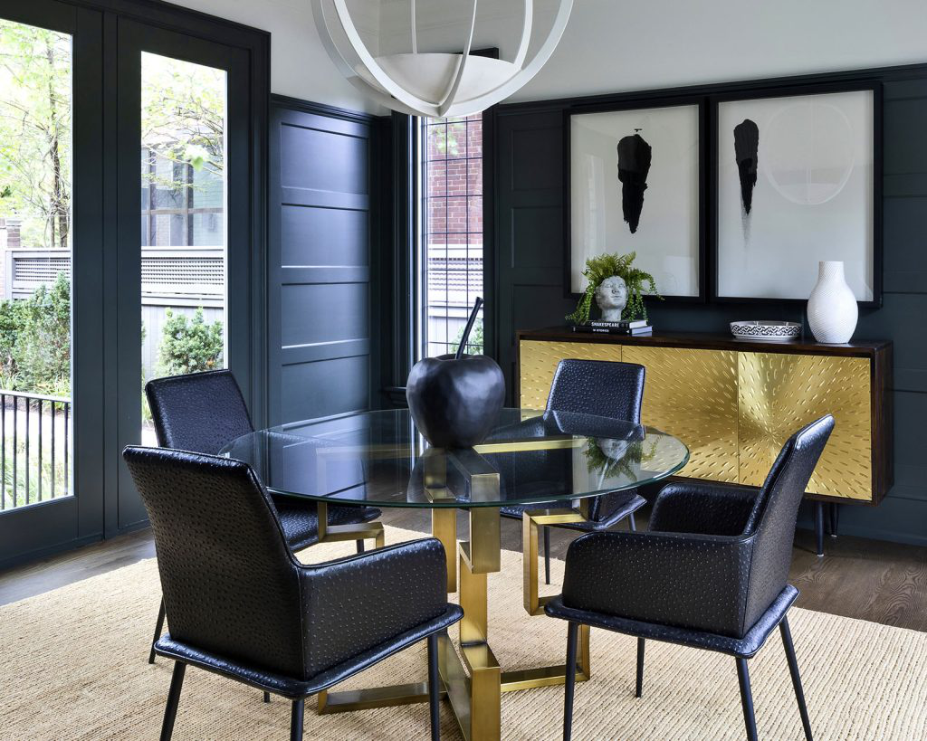 A large interior area with black tables and chairs.