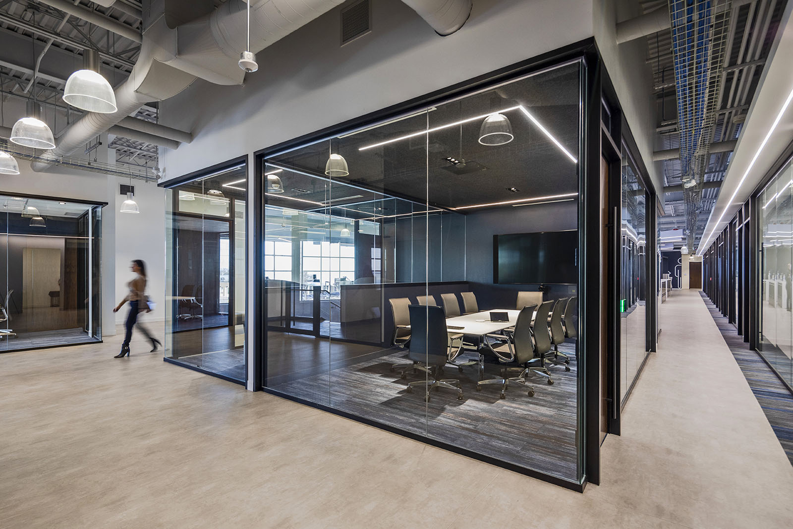 A large commercial office with huge glass windows.