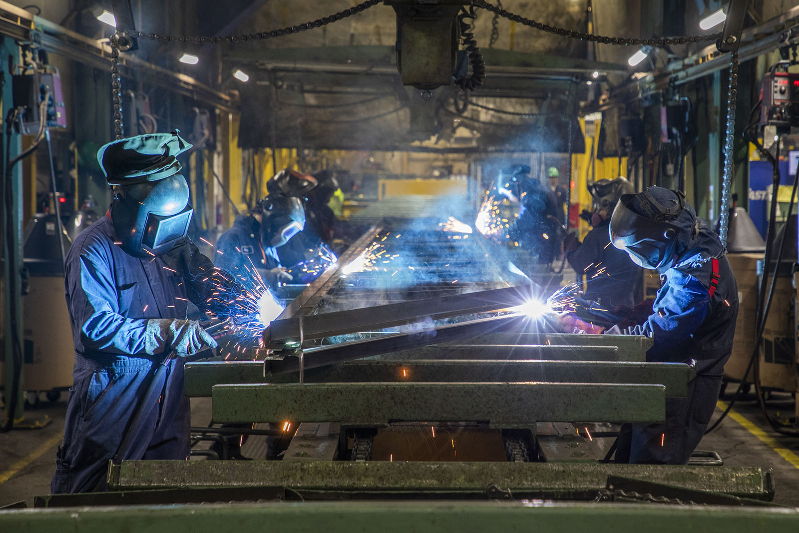 A large space with several machinery and workers.