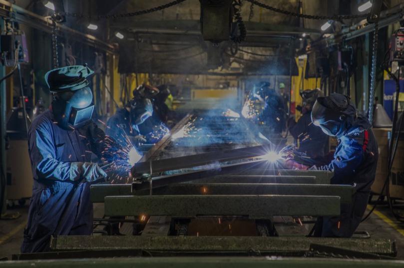A large space with people working on iron
