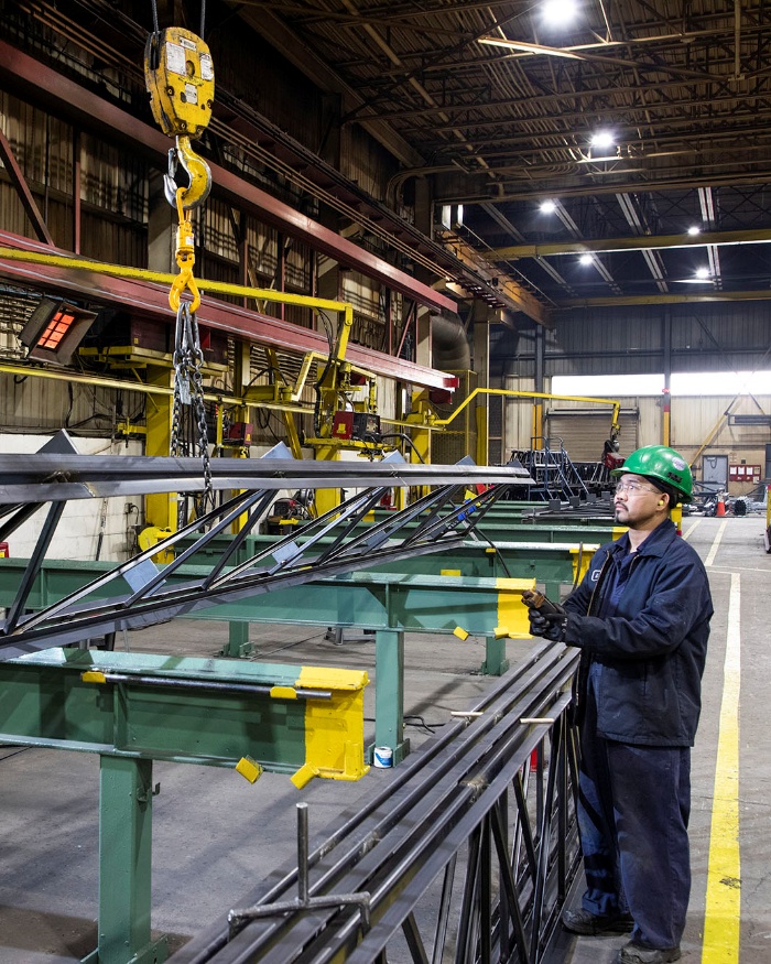 A man standing next to heavy machinery.