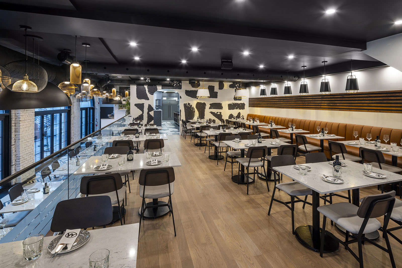 Warm pendant lighting and a wide-angle composition give this hospitality photography shot a sense of atmosphere before a single dish reaches the table.